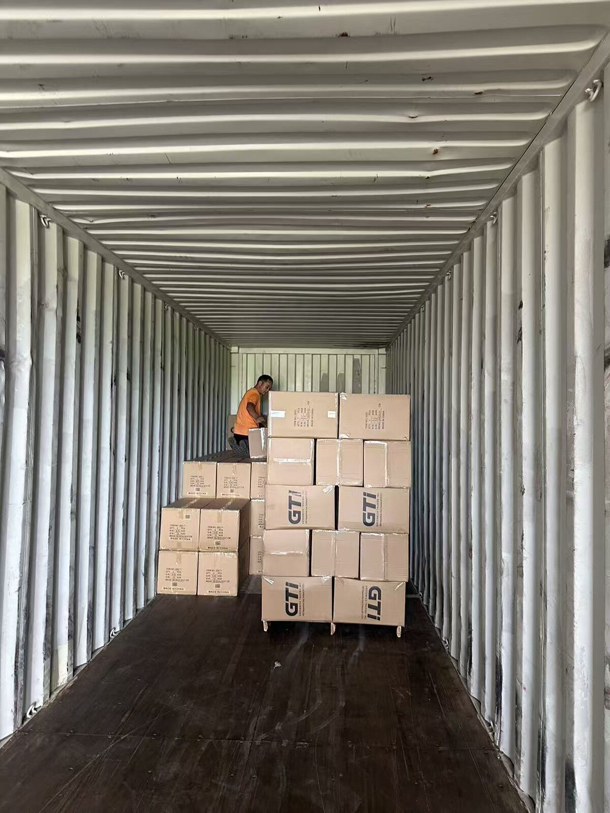 Cartons being prepared inside a shipping container